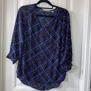 Plaid blouse with cute detail at neckline.